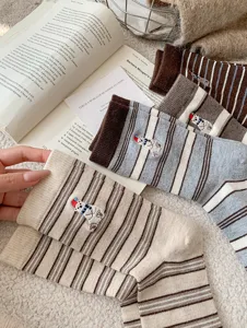 Cozy striped mid-calf socks with cute polar bear embroidery, soft winter knit detail.
