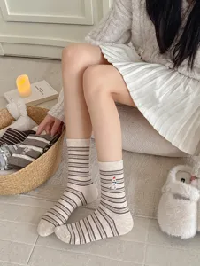 Detailed shot of cute striped winter socks featuring a sweet polar bear embroidery for daily wear.