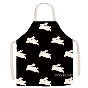 Black cotton apron featuring cute white running rabbit pattern and comfortable straps for cooking.