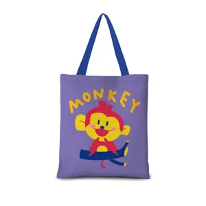 Sac cabas en toile violette avec une illustration de singe cartoon et des bretelles solides.