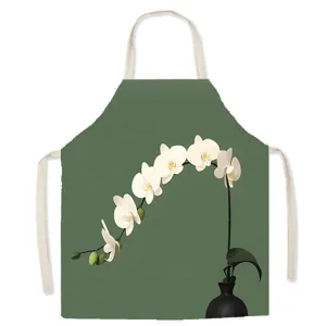 Close-up detail of Nordic green apron featuring elegant white orchid floral print.