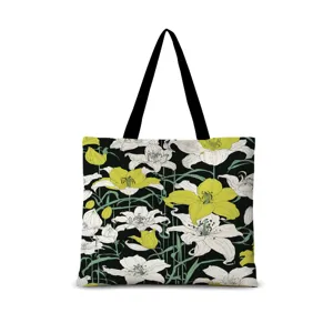 Sac cabas en toile avec imprimé floral de lys jaunes et blancs sur fond noir artistique.