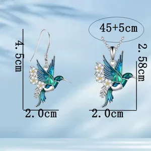Detailed view of the exquisite hummingbird and daisy pendant necklace and earrings set.