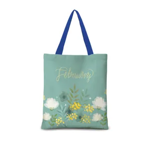 Vue détaillée d'un sac cabas en toile à fleurs vertes avec anses bleues et texte February.