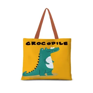 Borsa shopper in tela dopamina dettaglio con simpatico grafico di coccodrillo e spallacci marroni.
