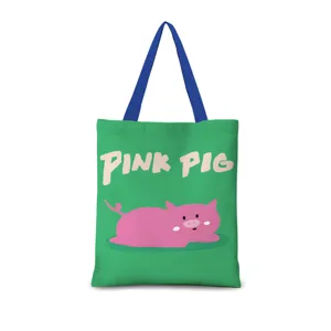 Dettaglio borsa shopper in tela verde, grafica maialino rosa e manici blu per uso quotidiano.