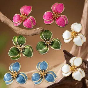 Detailed close-up of vintage enamel flower earrings featuring multi-color options and gold edges.
