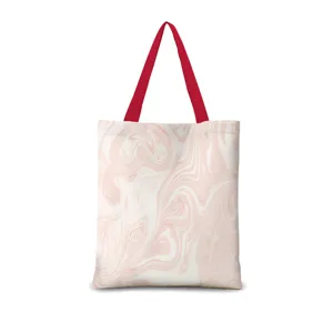 Sac cabas en toile avec motif marbre rose et anses rouges pour les cours et le travail.