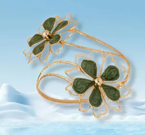 Exaggerated hollow flower arm cuff with green enamel petals and gold tone, chic jewelry detail.