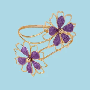 Fashionable double flower hollow cuff bracelet with purple enamel and gold tone for women.