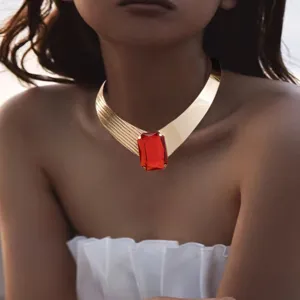 Chic wide gold choker necklace featuring a striking central rectangular red gemstone detail.