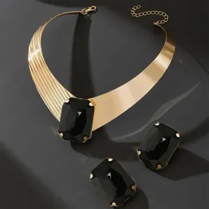 Exquisite gold-toned choker necklace and matching rectangular black stone earrings set.