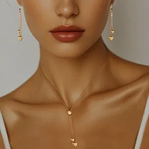 Elegant gold-tone lariat necklace and matching long heart drop earrings set for women.