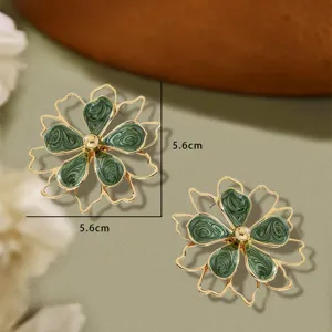 Chic hollow double-layer enamel flower earrings detail, elegant green floral stud design.