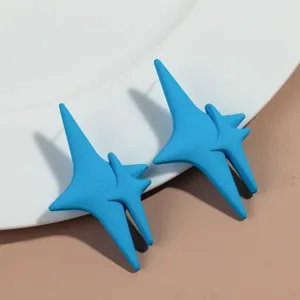 Blue star stud earrings detail view, matte finish minimalist geometric fashion jewelry.