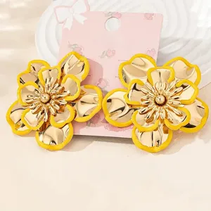 Close-up detail shot of exquisite gold flower earrings with yellow enamel edge design.