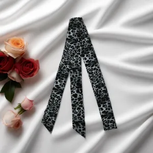 Leopard print slim silk scarf close-up, stylish Y2K neck ribbon and chic choker detail.