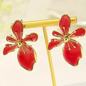 Red enamel flower earrings with gold plated frame, stylish detail view fashion jewelry.