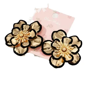 Chic gold flower earrings with black outline, stylish floral jewelry for women daily.