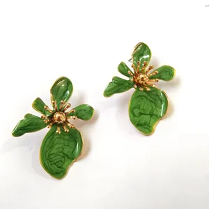 Stunning green enamel flower earrings with gold-toned accents, perfect for summer style.