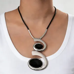 Exquisite detail view of the European bohemian spiral necklace with black oval acrylic stones.