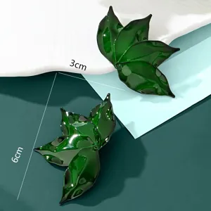 Exaggerated green leaf shaped stud earrings for women, retro fashion statement jewelry.