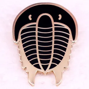 Detailed view of the trilobite fossil metal brooch showing clear black enamel and gold outlines.