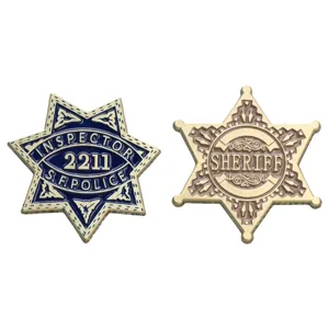 Detailed close-up of retro metal six-pointed star sheriff badges with enamel and relief text.