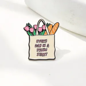 Enamel brooch pin featuring tulip and baguette shopping bag design for stylish decoration.