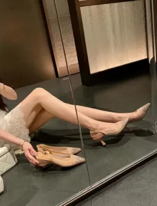 Detail view of stylish pointed-toe mesh slingback heels with sparkling rhinestones and stable heel.