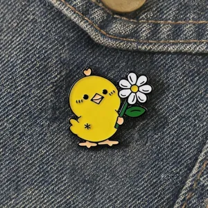 Cute yellow chick holding daisy brooch enamel pin badge for clothes and bags decoration details.