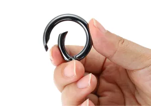 Close up view of black metal spring ring clasp, perfect for DIY jewelry and keychains.