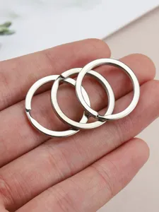 Close-up view of shiny metal split rings, flat double-layer key rings for DIY accessories.