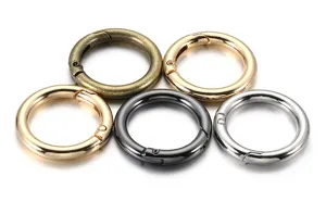 Detail view of round metal spring snap hooks in various metallic finishes for DIY craft projects.