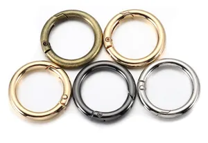 Detail view of openable metal spring rings in five metallic finishes for DIY crafts.