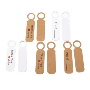 Detail view of kraft paper and white card hang tags with handmade thank you print and price lines.