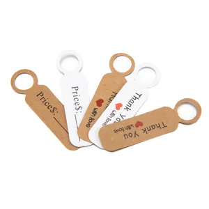 Close-up detail of craft paper hang tags with circular holes, price lines, and thank you text.