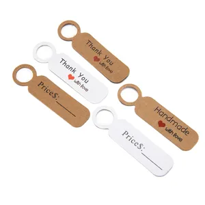 Kraft paper thank you tags and price labels detail view showing elegant text and hanging hole.