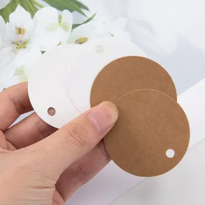 Blank round paper hang tags detail view, kraft paper and white card labels for DIY gifts.