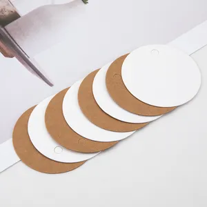 Close-up of round blank kraft paper and white hang tags with punch holes, ideal for DIY gifts.