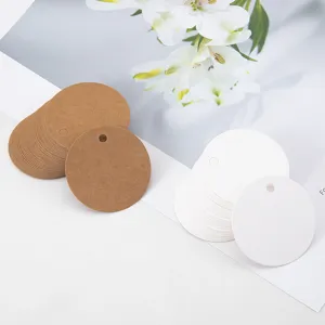 Round blank craft paper tags with pre-punched holes for DIY gift wrapping and labeling.