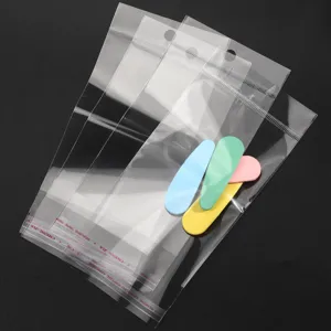 Clear transparent self-adhesive OPP packaging bags with hanging holes for accessories.