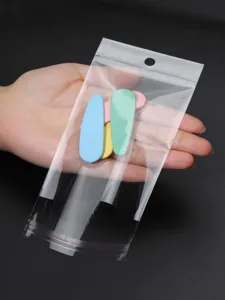 Transparent self-adhesive OPP packaging bag with colorful hair clips for small accessories.