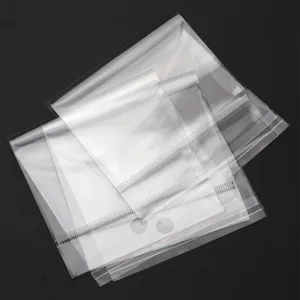 Transparent self-adhesive OPP plastic packaging bags stacked neatly for cards and jewelry.