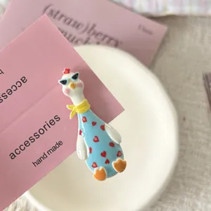 Simpatica molletta per capelli a forma di oca con occhiali da sole per bambini e stile.