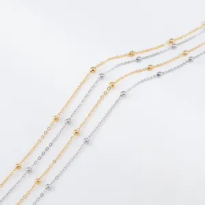 Detailopname van roestvrijstalen kraalletjeskettingen met gouden en zilveren metalen afwerking.