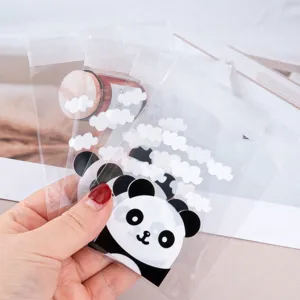 Clear OPP self-sealing bags featuring cute panda and white cloud prints for packaging snacks.