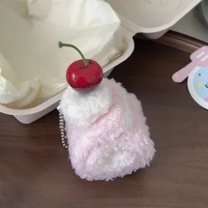 Cute cake roll plush keychain with cherry charm, soft dessert bag pendant detail view.