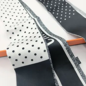 Black and white polka dot silk twilly scarf for handbag handle or hair band accessory.