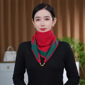 Detailed view of the red and green knit triangle scarf with metal chain, warm winter neck warmer.